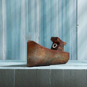 small hand carving of wooden fishing boat