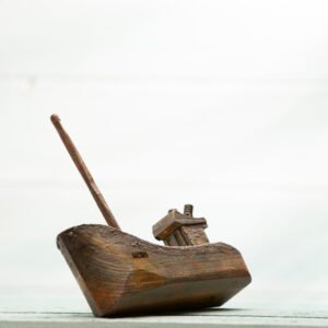 small hand carved wooden fishing boat