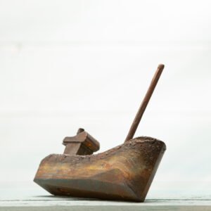 small hand carved wooden fishing boat